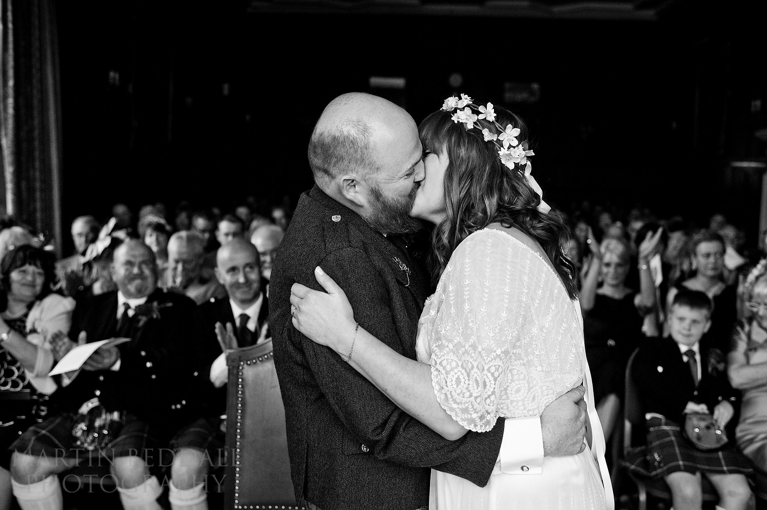 Bride and groom kiss at Bisham Abbey wedding ceremony