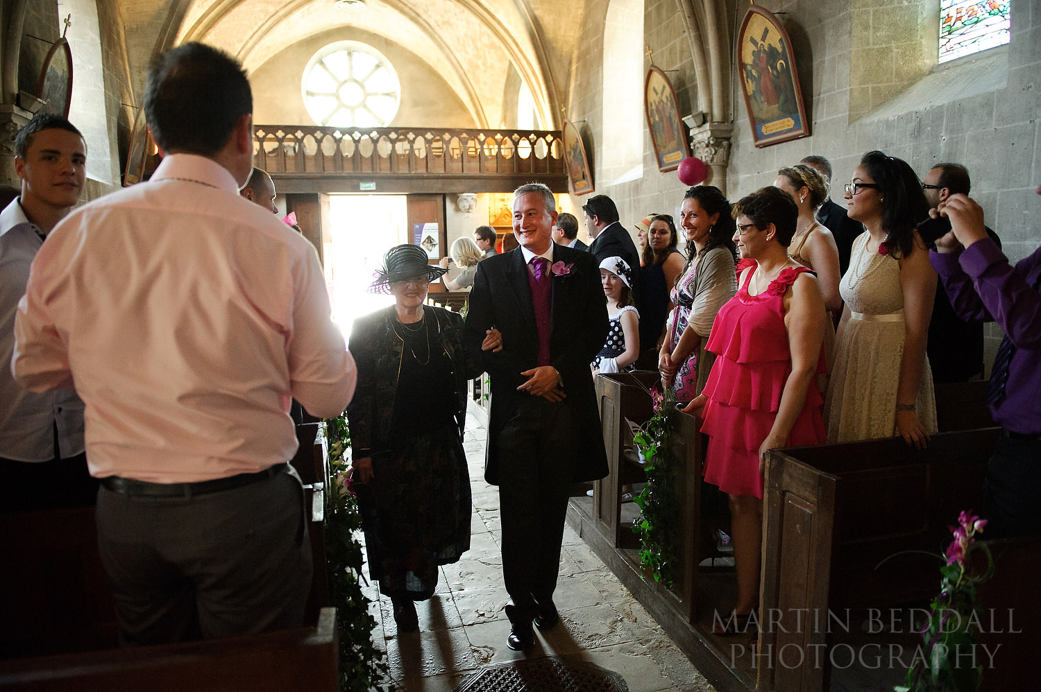 Groom walks down the aisle with his mother
