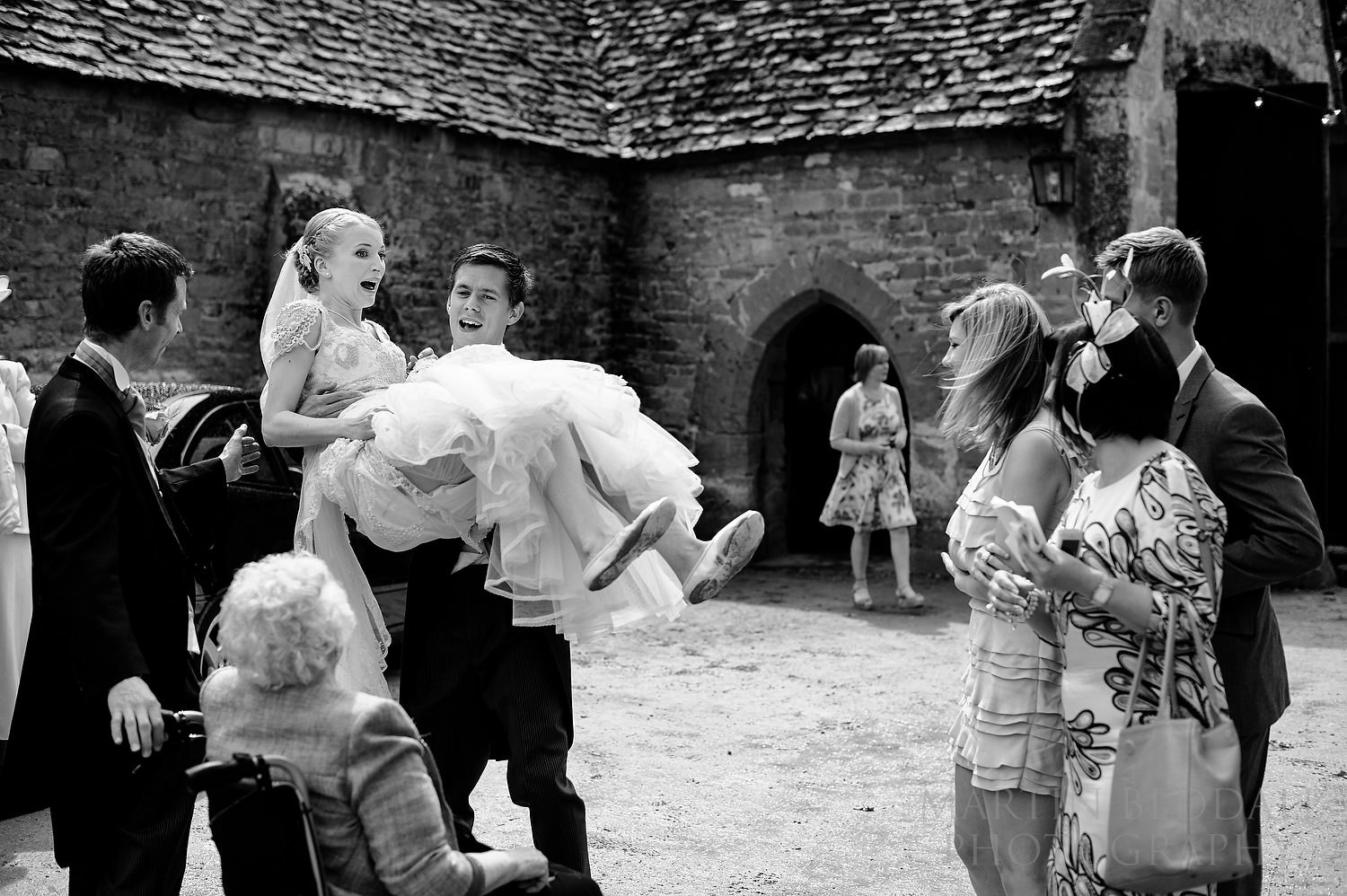 Groom carrying the bride