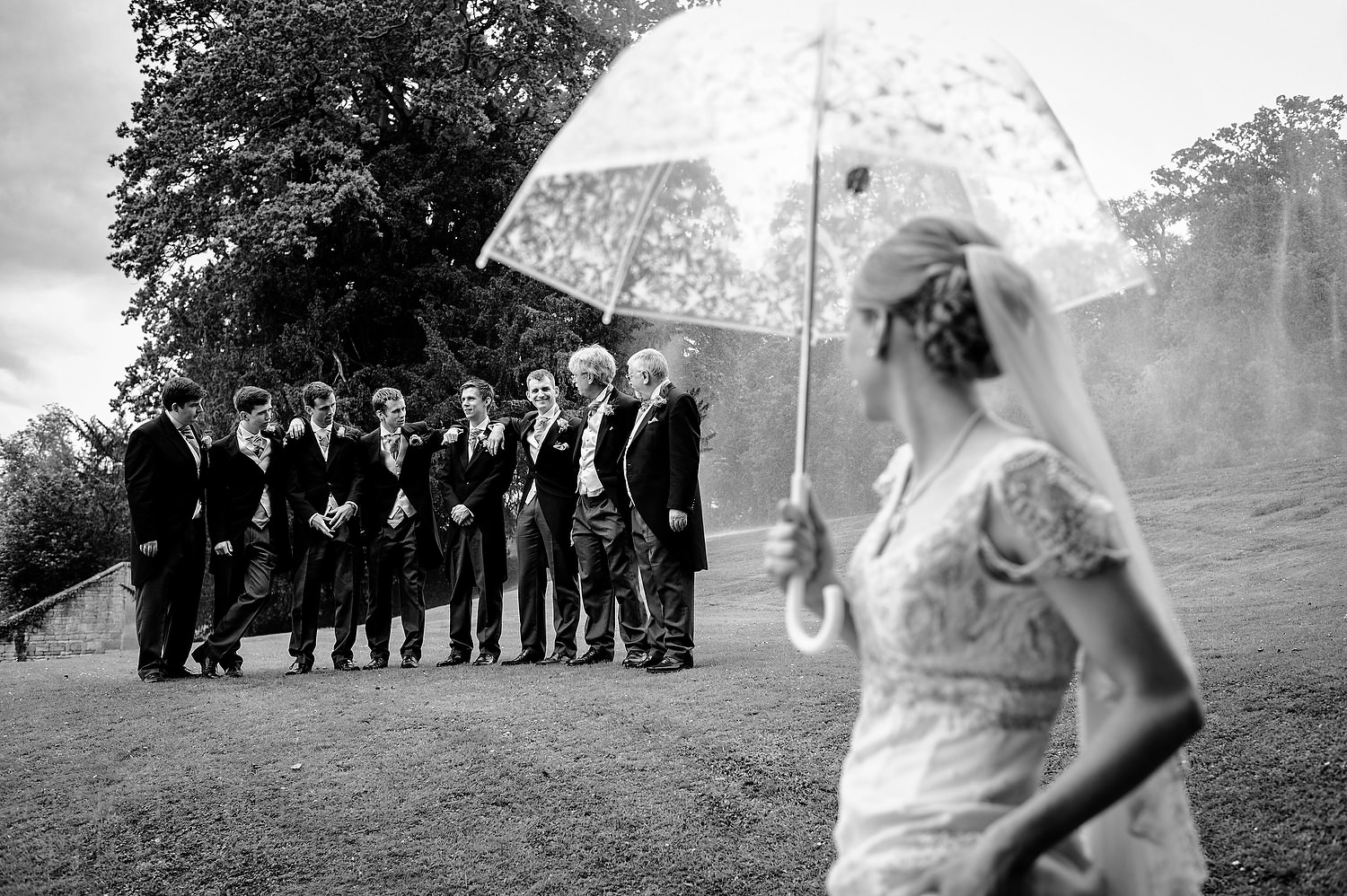 Posing by the fountain at Stanway House wedding