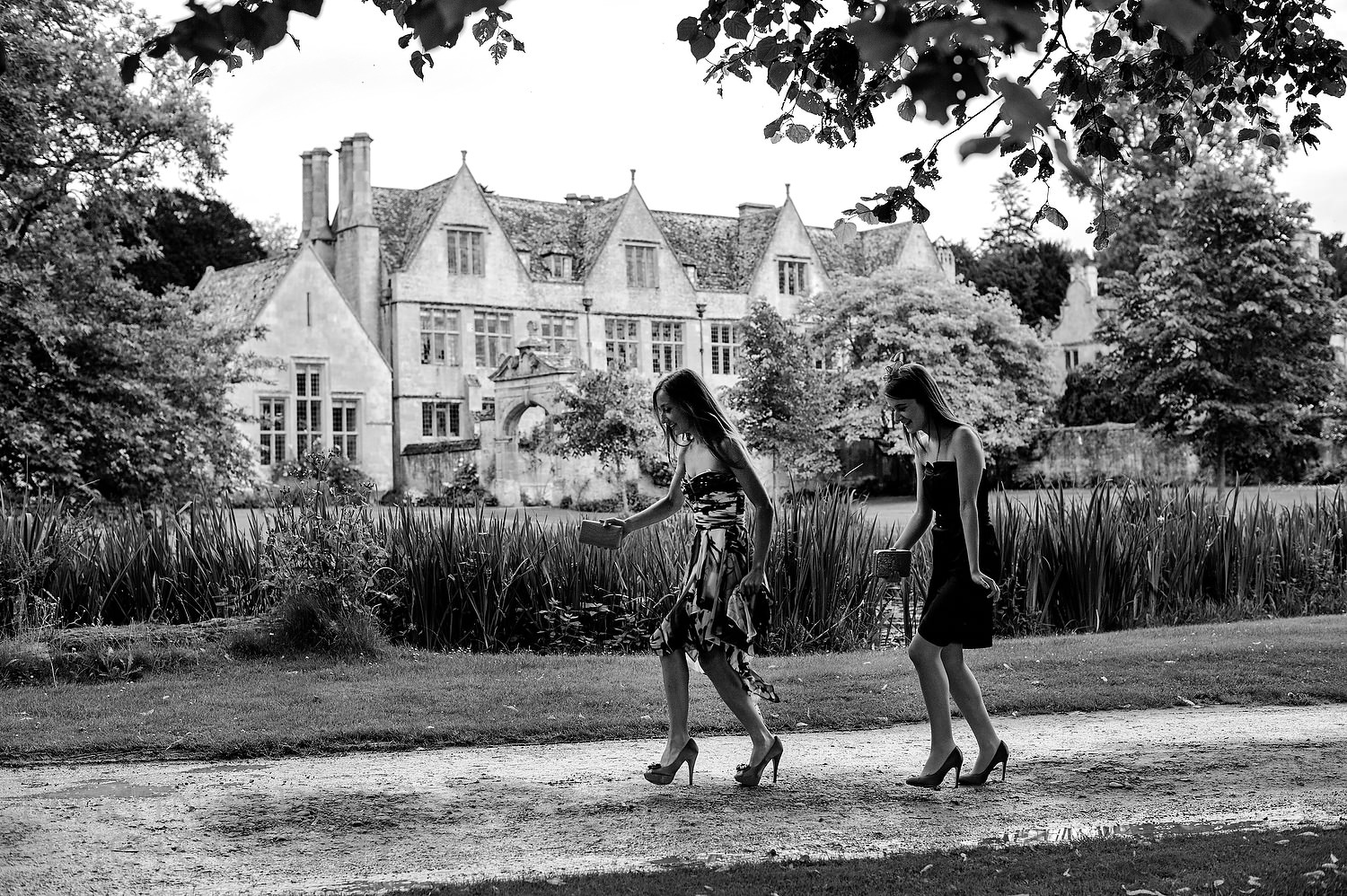 Walking in the rain at Stanway House wedding