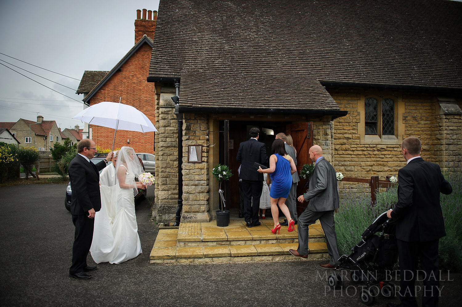 Bride waits for late guests to go into the church