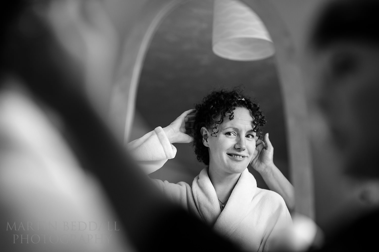 Bride looks into a mirror