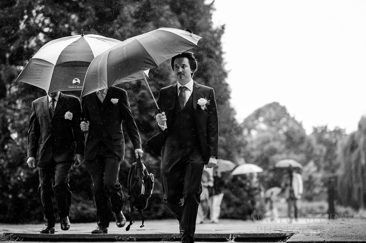 Groom arrives in the rain at Pershore Abbey