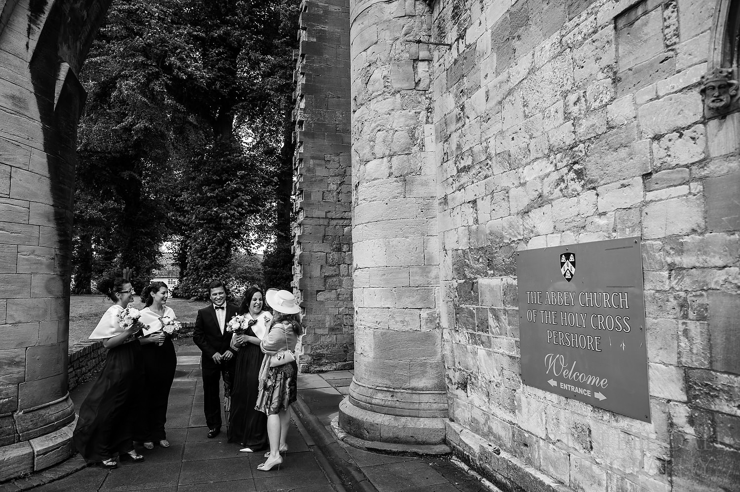 Bridesmaids wait outside the Abbey Church of the Holy Cross Pershore