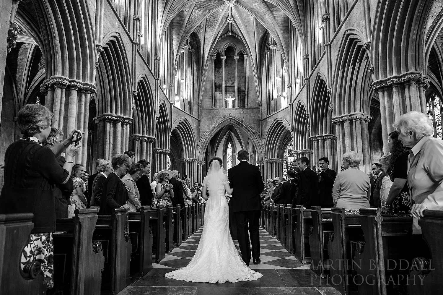 Bride and her father walk down the aisle at Pershore Abbey wedding