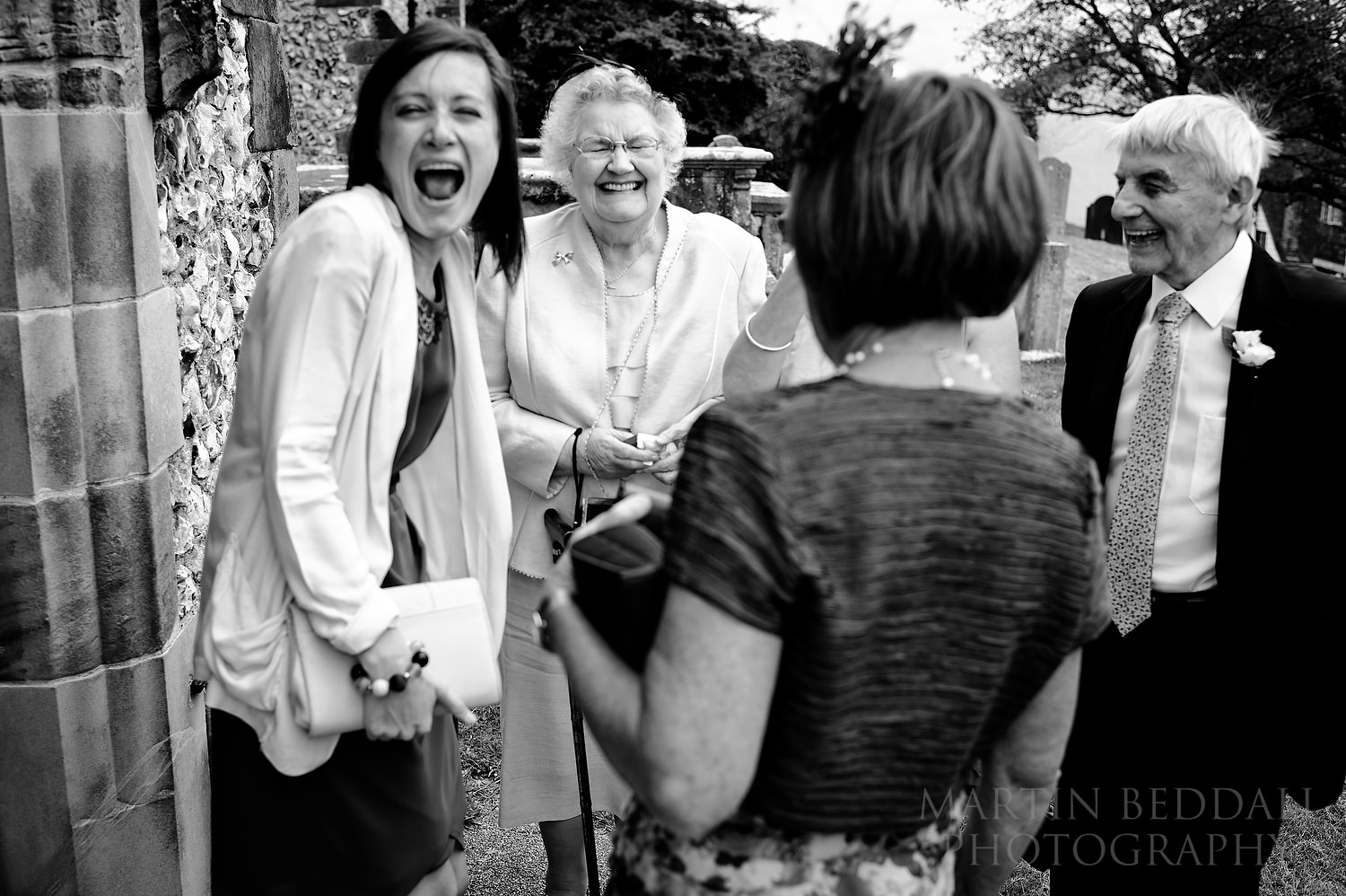 Laughing wedding guests