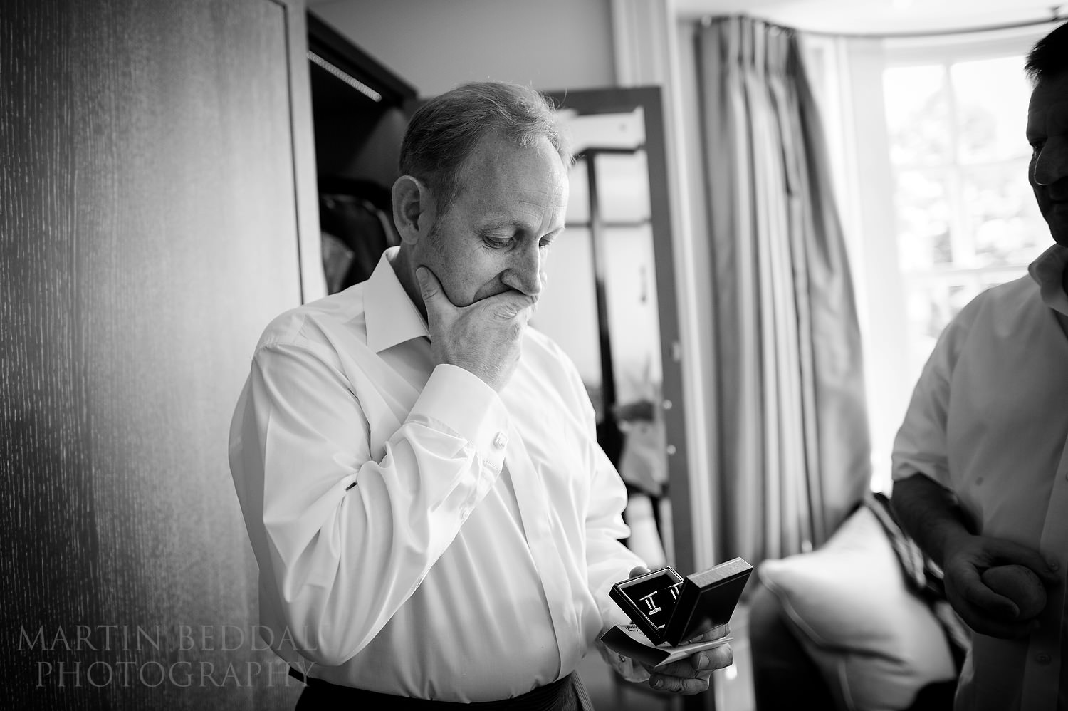 Groom receives a present of cufflinks from the bride