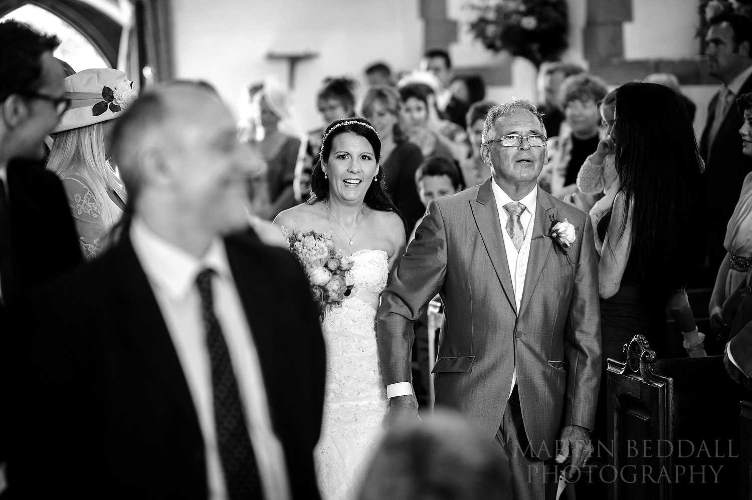 Bride and her father walk down the aisle at Ditchling church