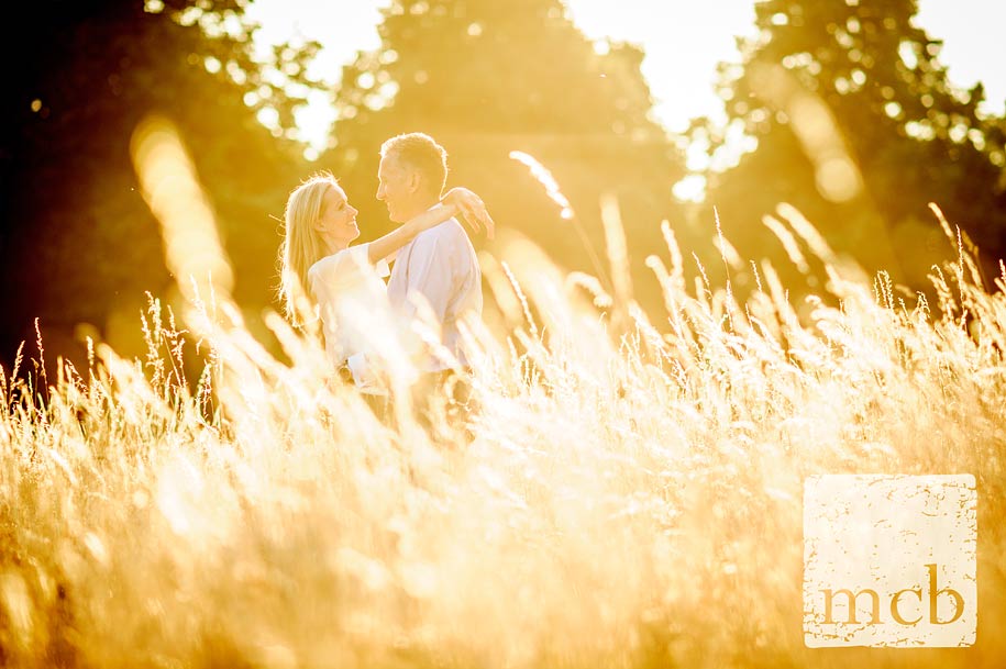 Smiling women with her arms around her man's neck in the evening sunlight