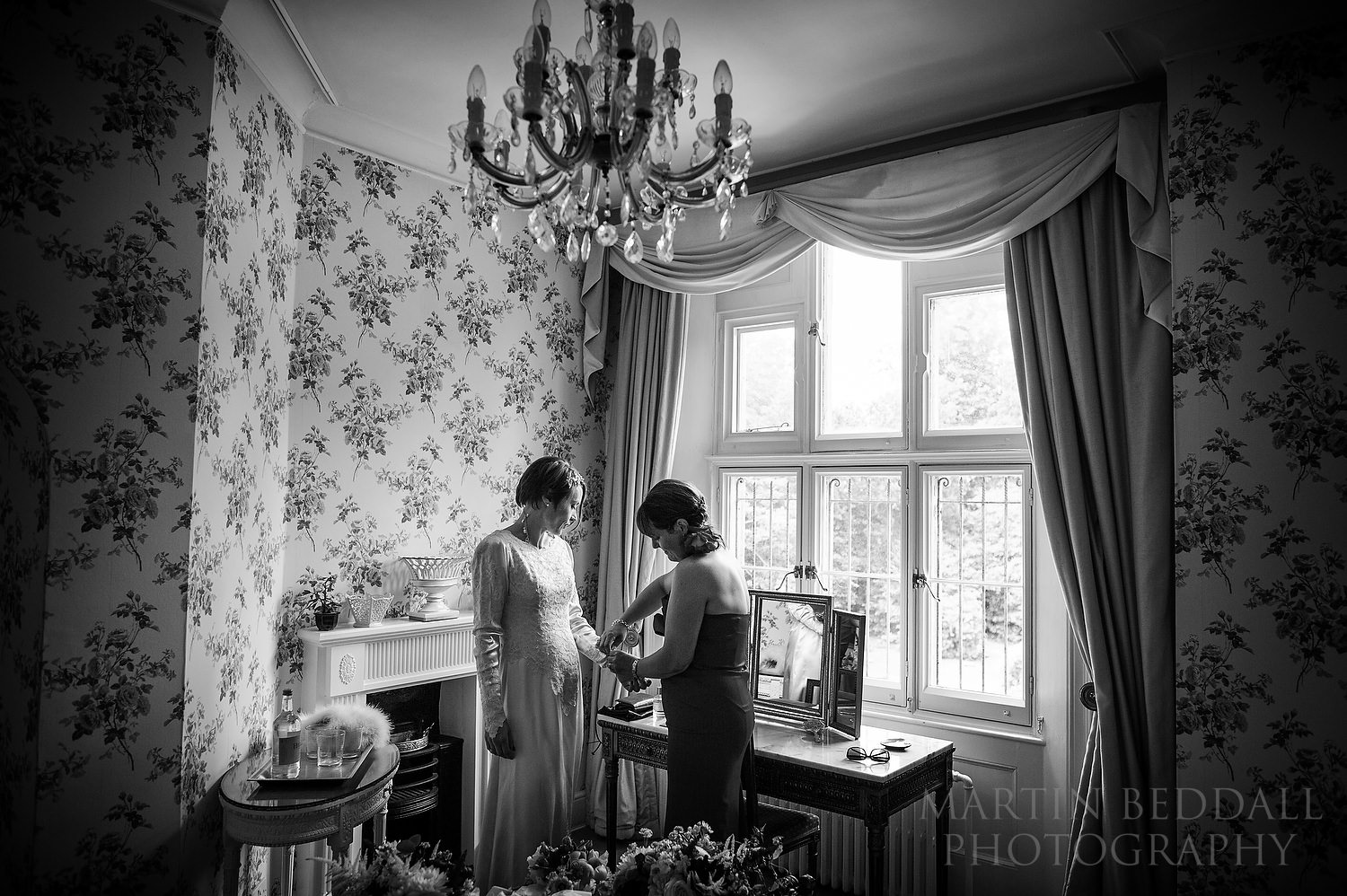 Bride getting ready with a friend at Wadhurst Castle