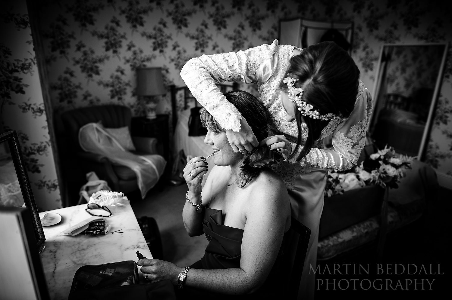 Bride helps with her friend's hair
