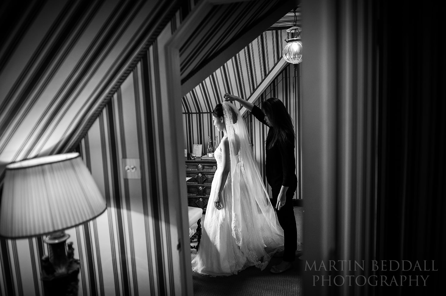 Bride gets into her wedding dress at Great Fosters