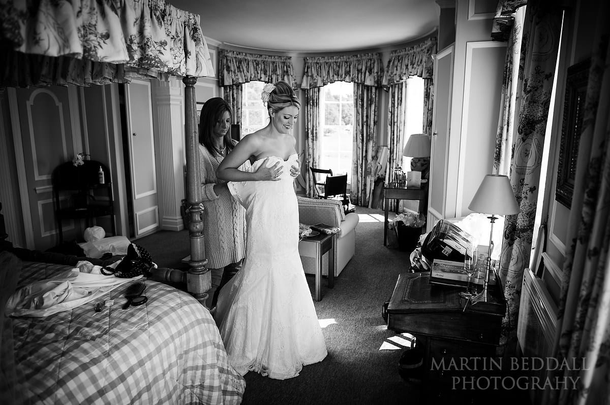 Bride getting dressed at Newick Park