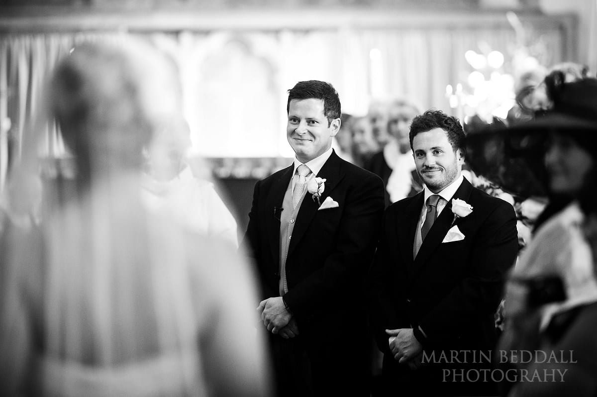 Groom watches the bride walk down the aisle