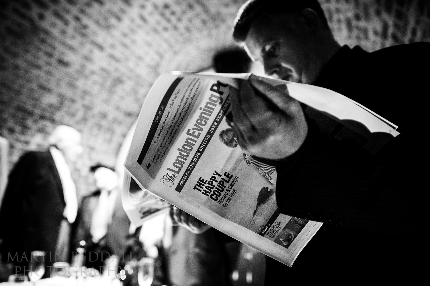 Guest reads wedding newspaper