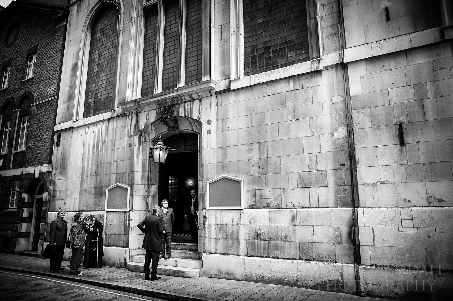 Groom waits outside St Vedast alias Foster church wedding