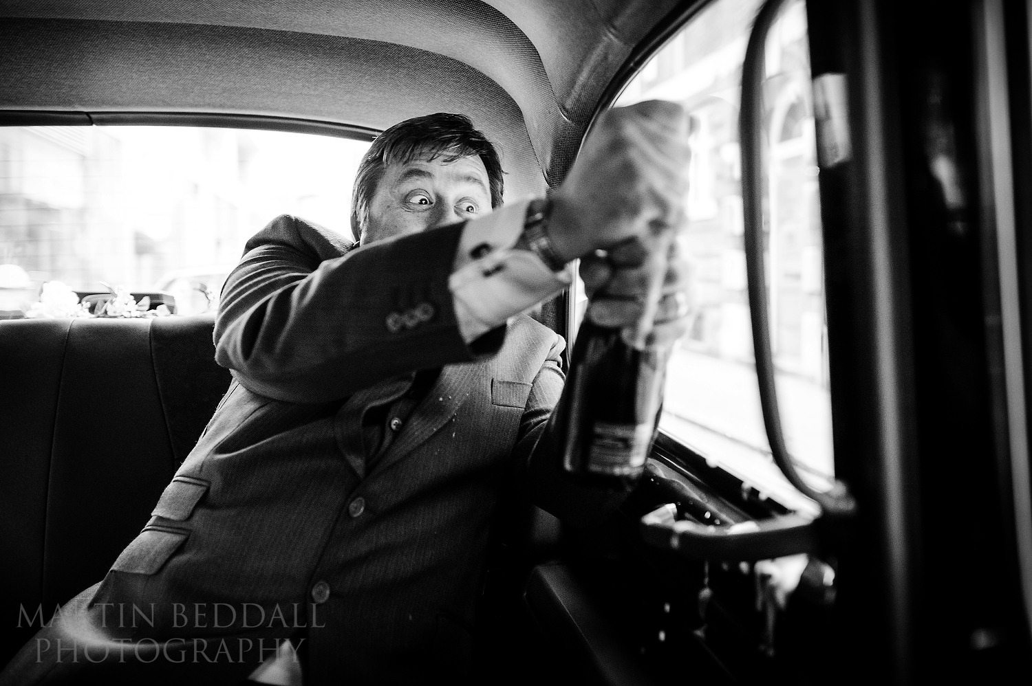 Opening champagne in the taxi