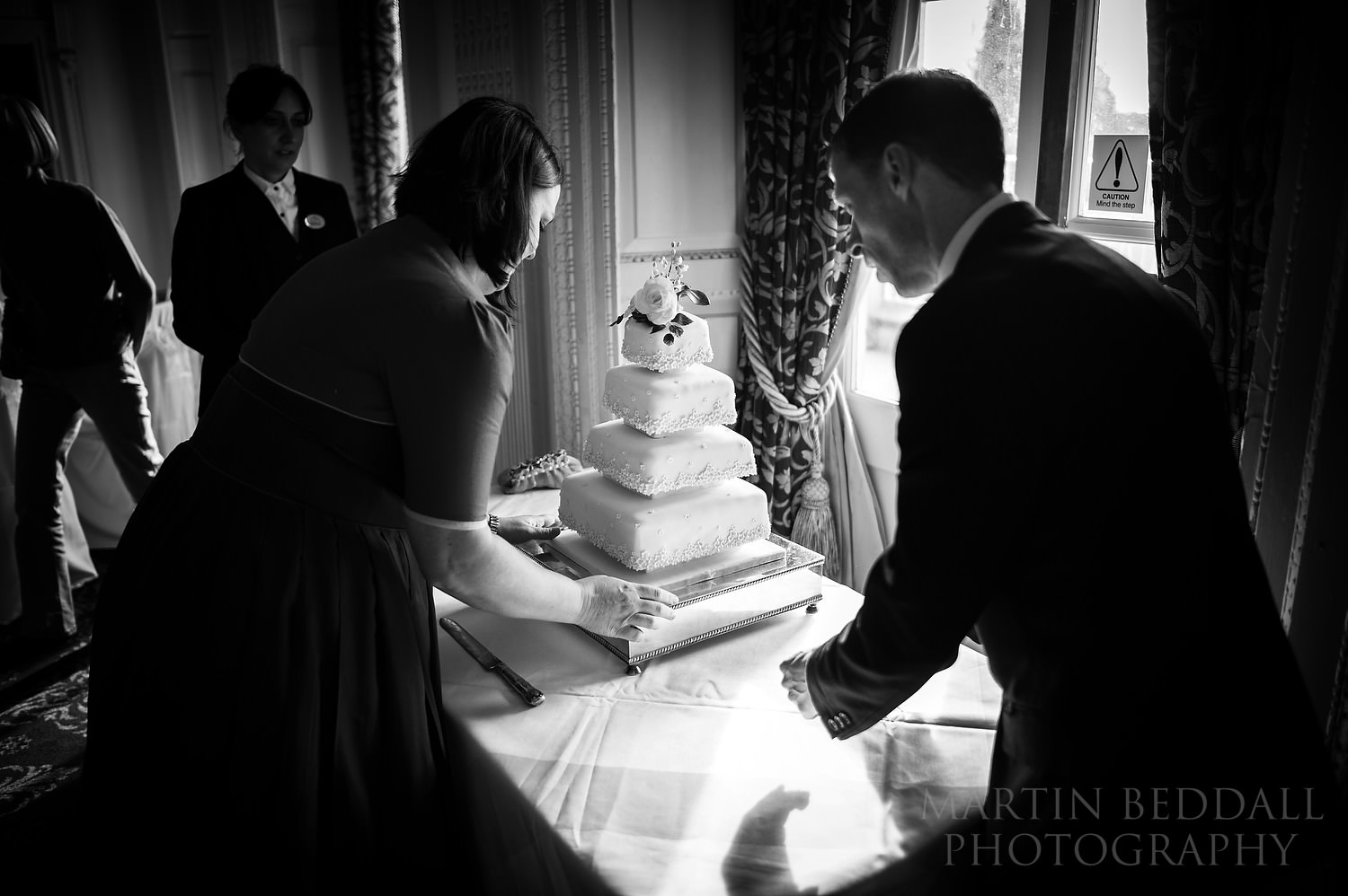 Setting up the wedding cake at Buxted Park wedding