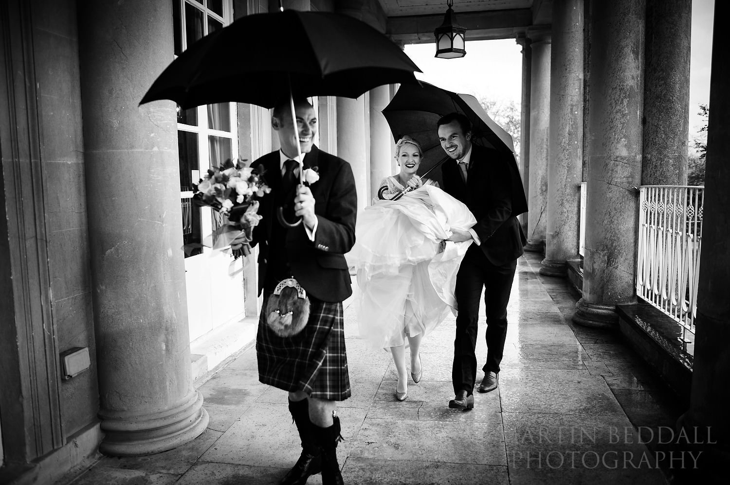 Dodging the rain at Buxted Park wedding