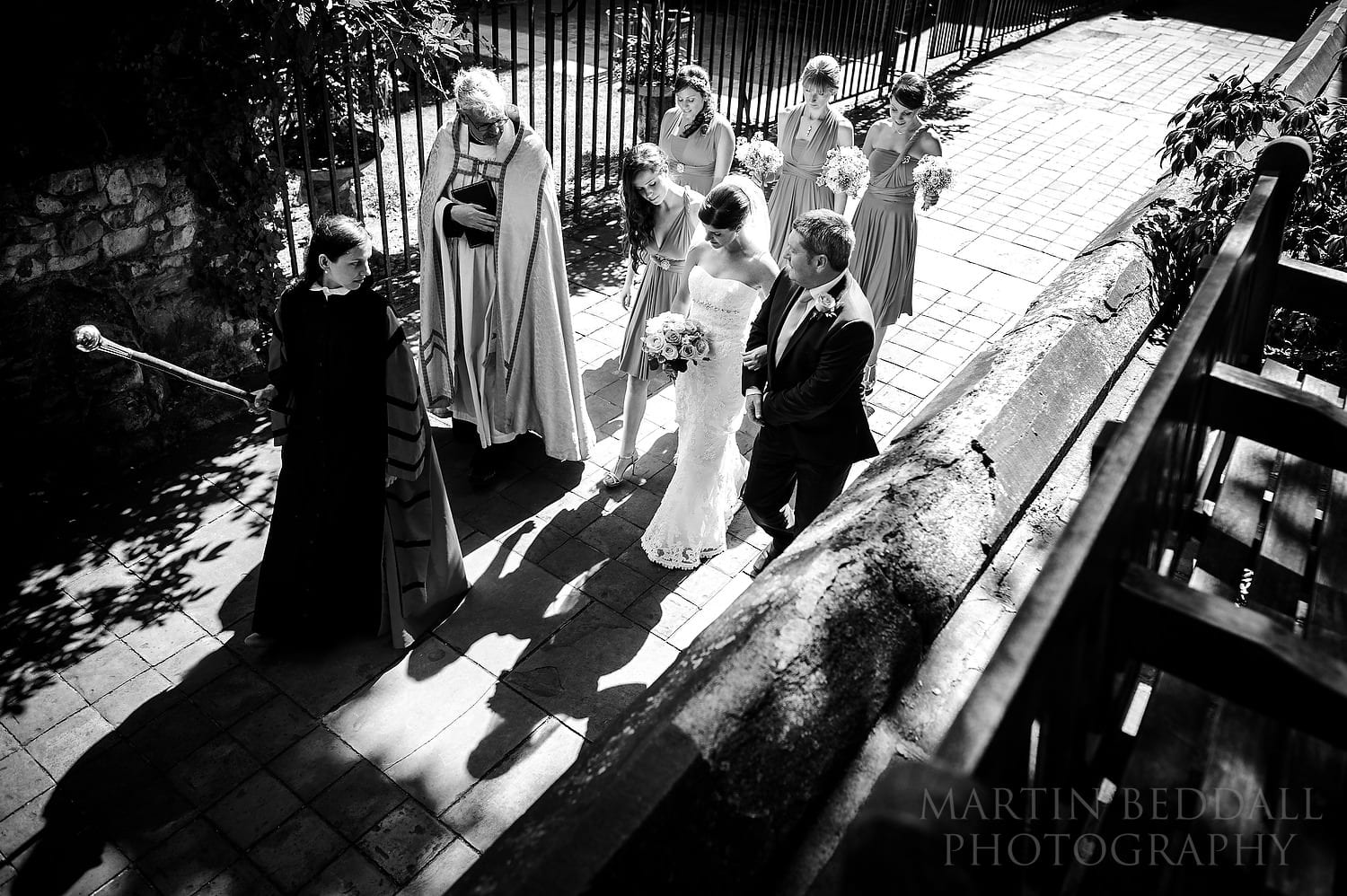 Bride walks towards St Bart's church in London