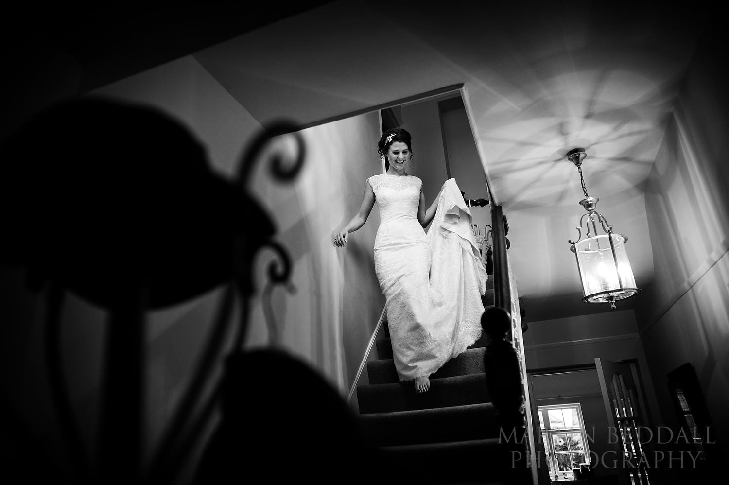 Bride walks down the stairs in her wedding dress
