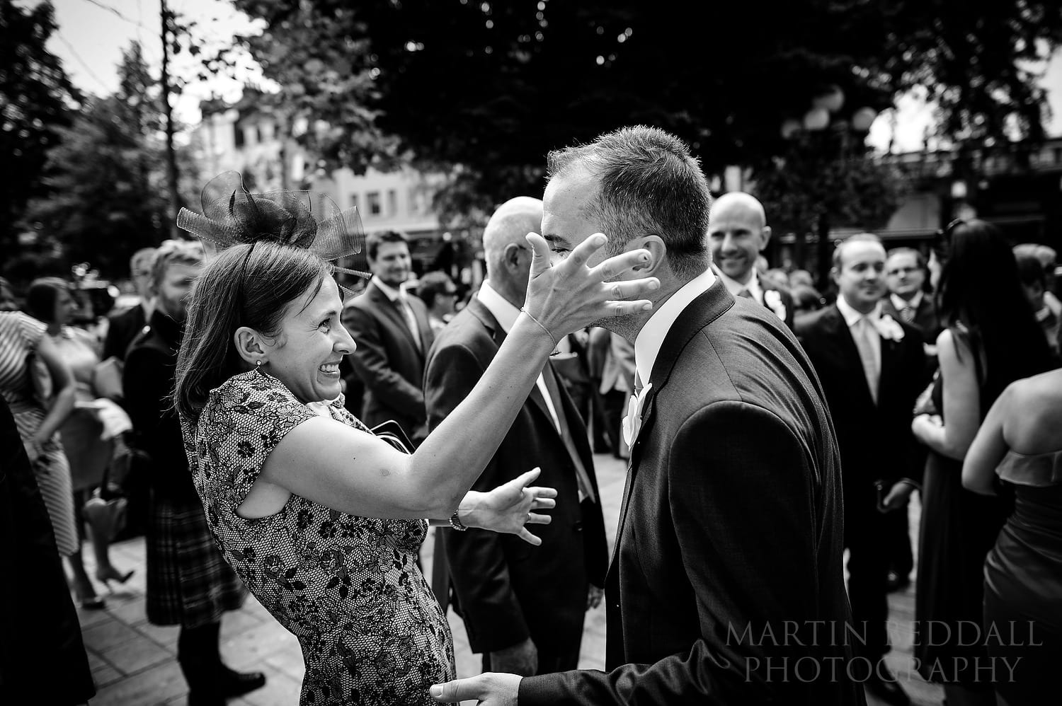 Excited guest greets the groom outside Islington Town Hall