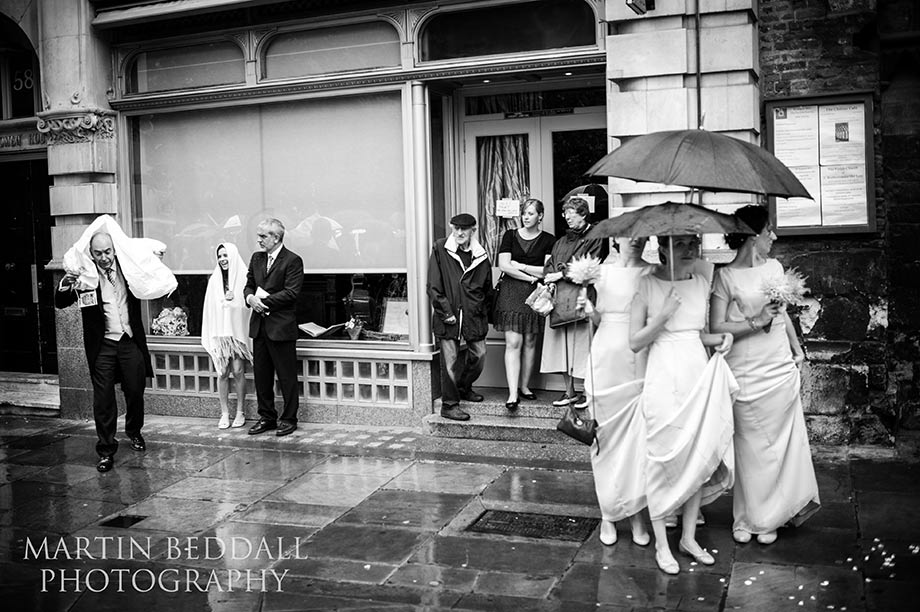 Wedding guests shelter from the rain