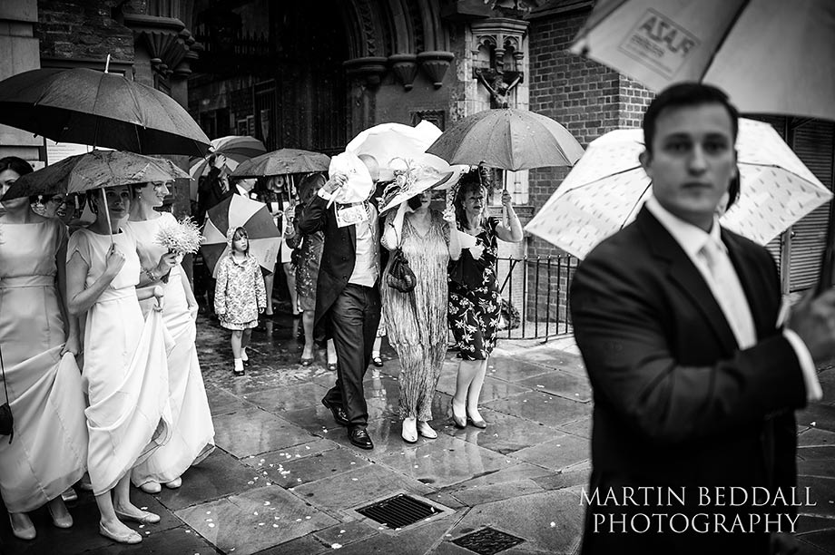 Wedding guests leave St Barts under umbrellas