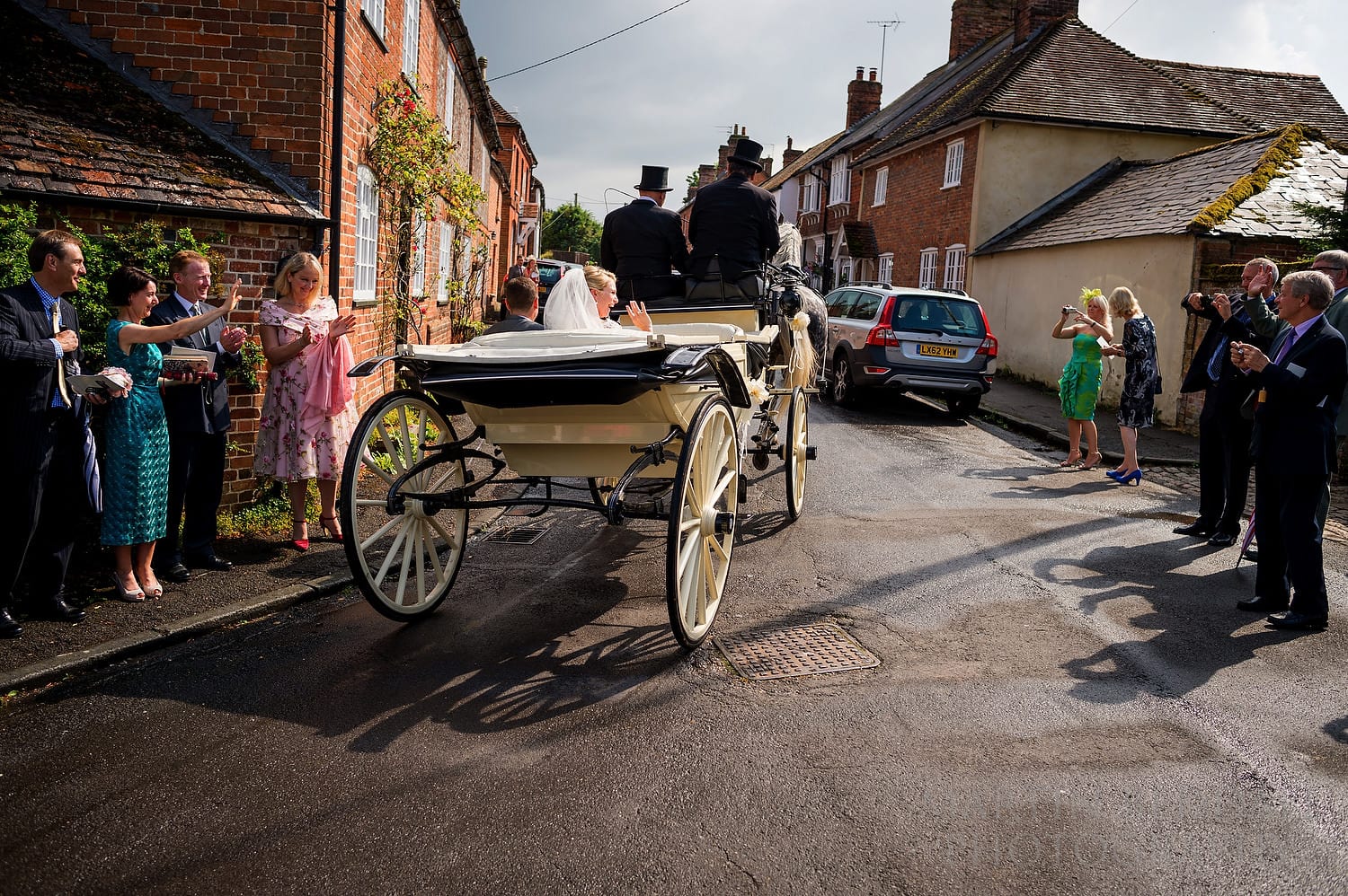 Bride and groom leave the church in the horsedrawn carriage