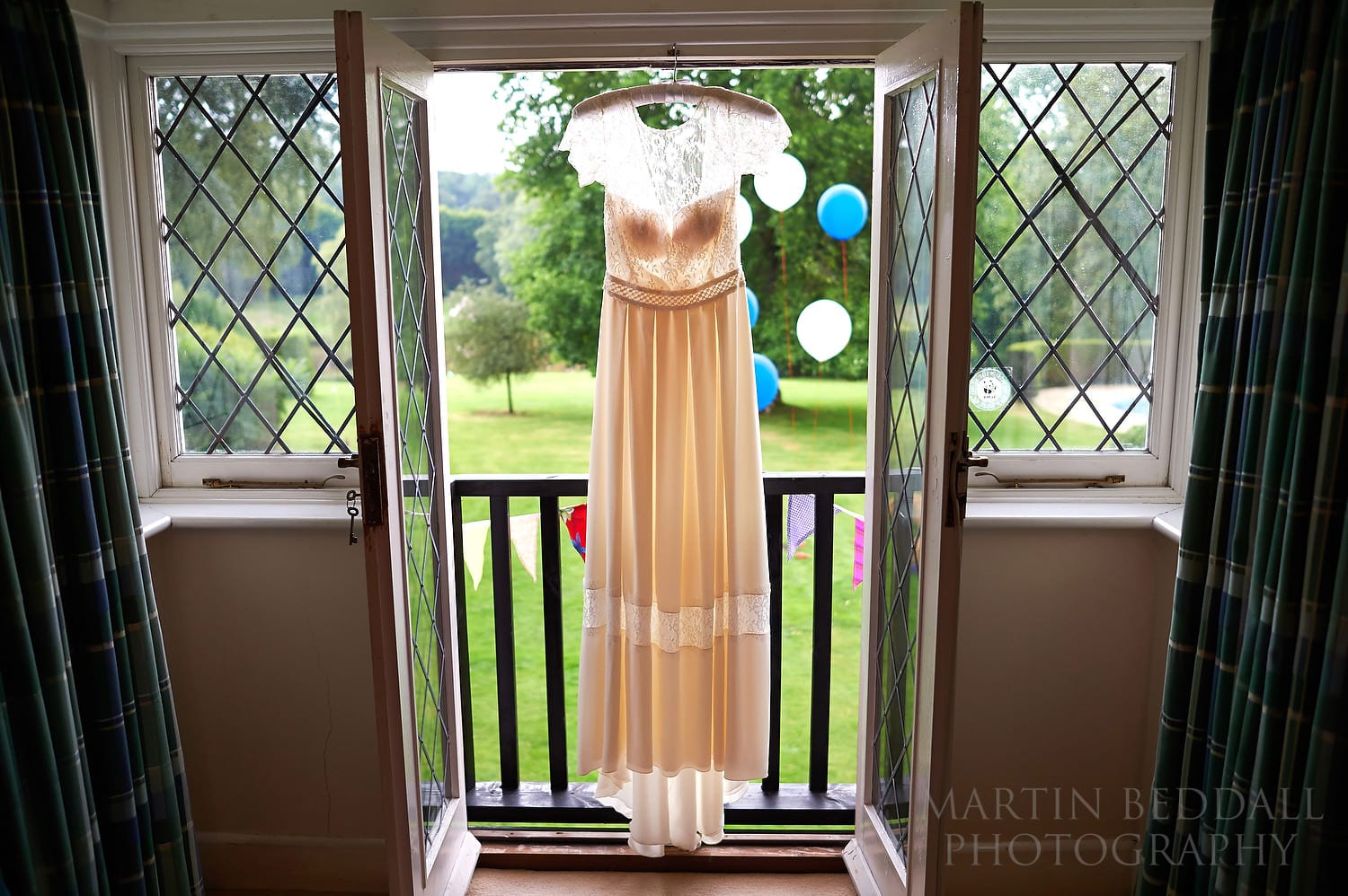 Wedding dress hanging in the window