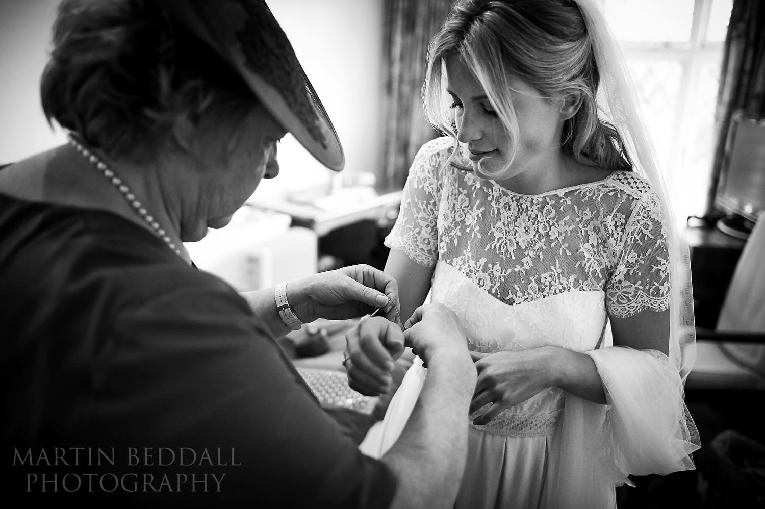 Bride's mother helps with the jewellry