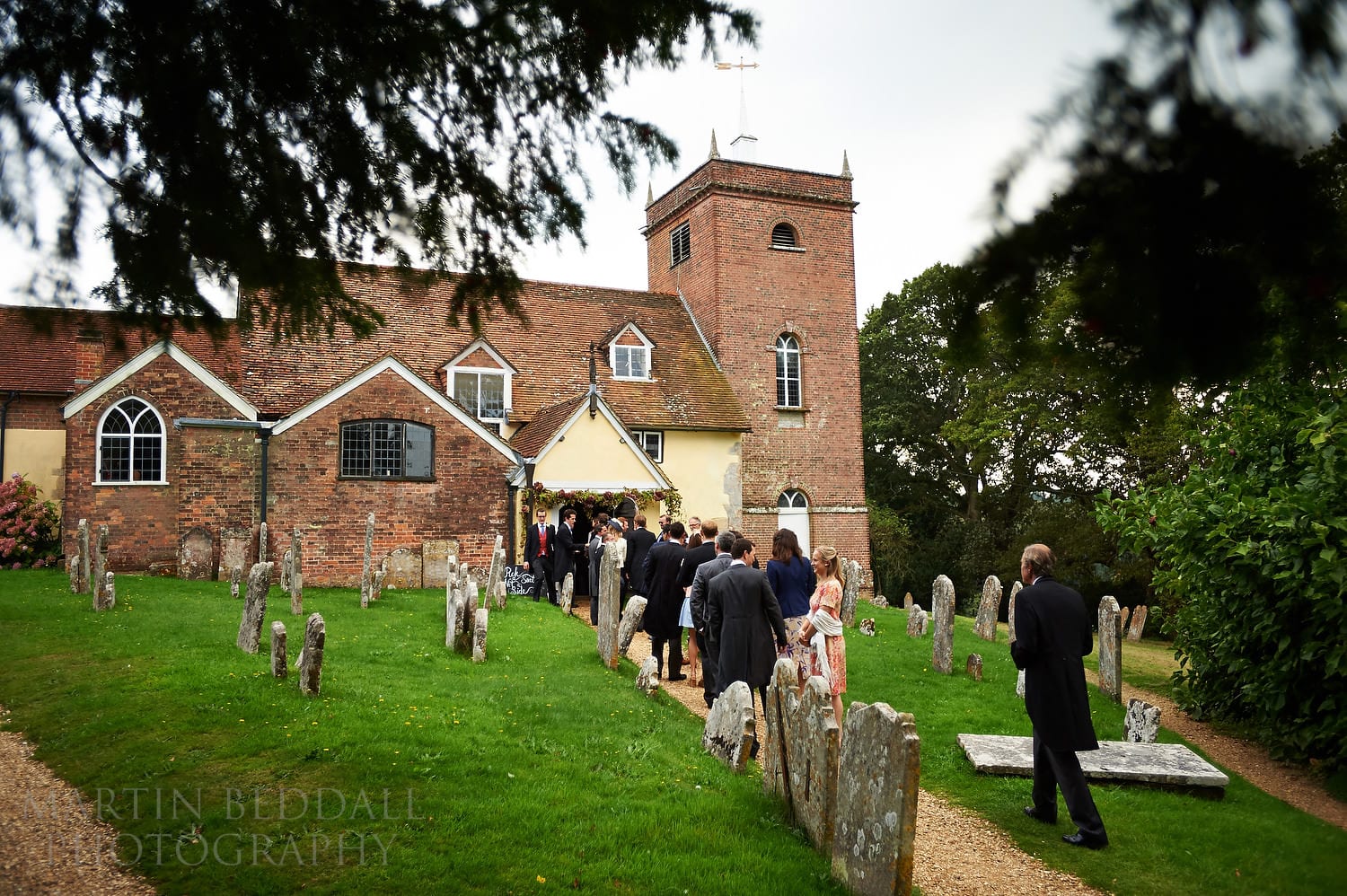 Wedding guests head into All saints Church in Minstead