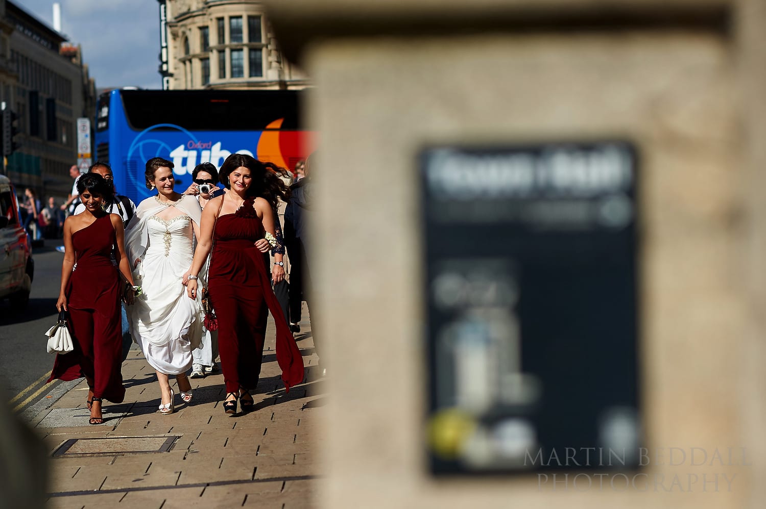 Bride and her bridesmaids walking to Oxford Town Hall