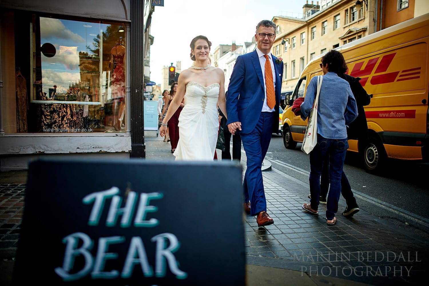 Bride and groom walking down Oxford High Street