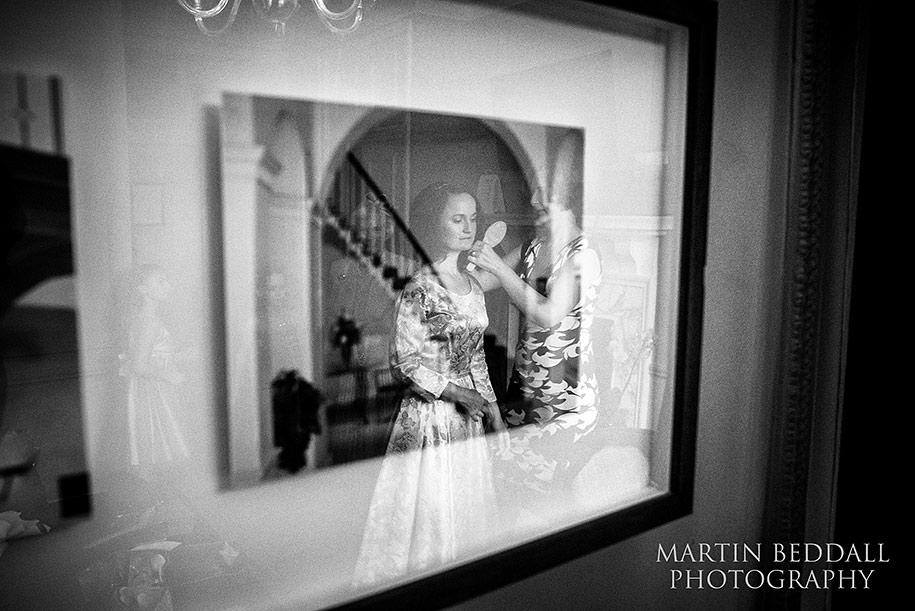 Bride getting ready reflected in a picture