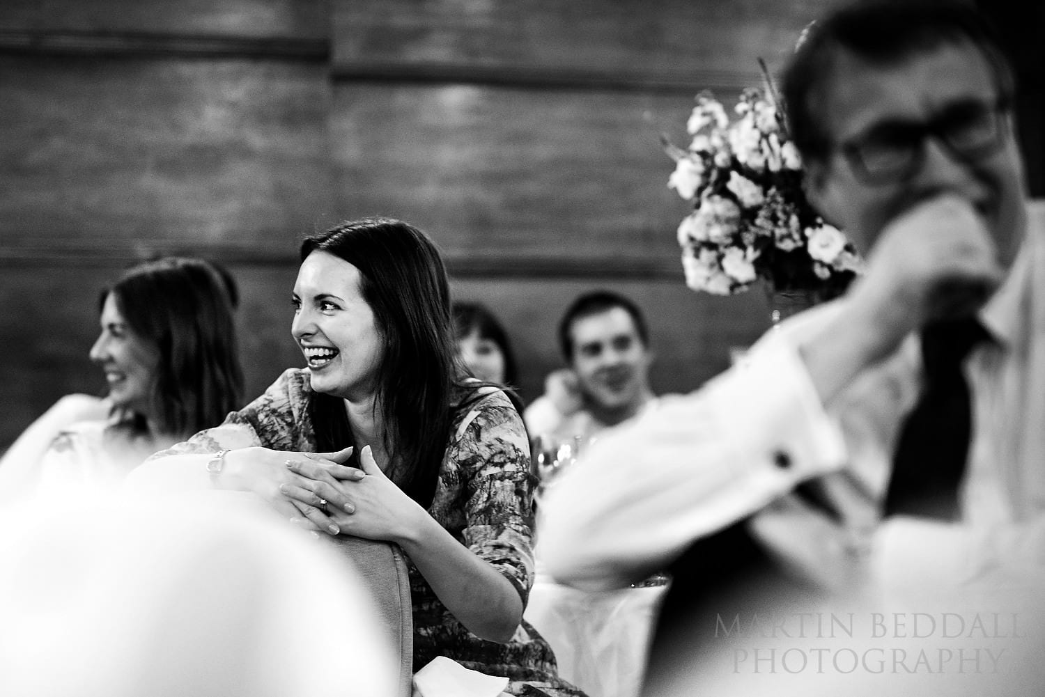 Wedding guests laughing at the speeches