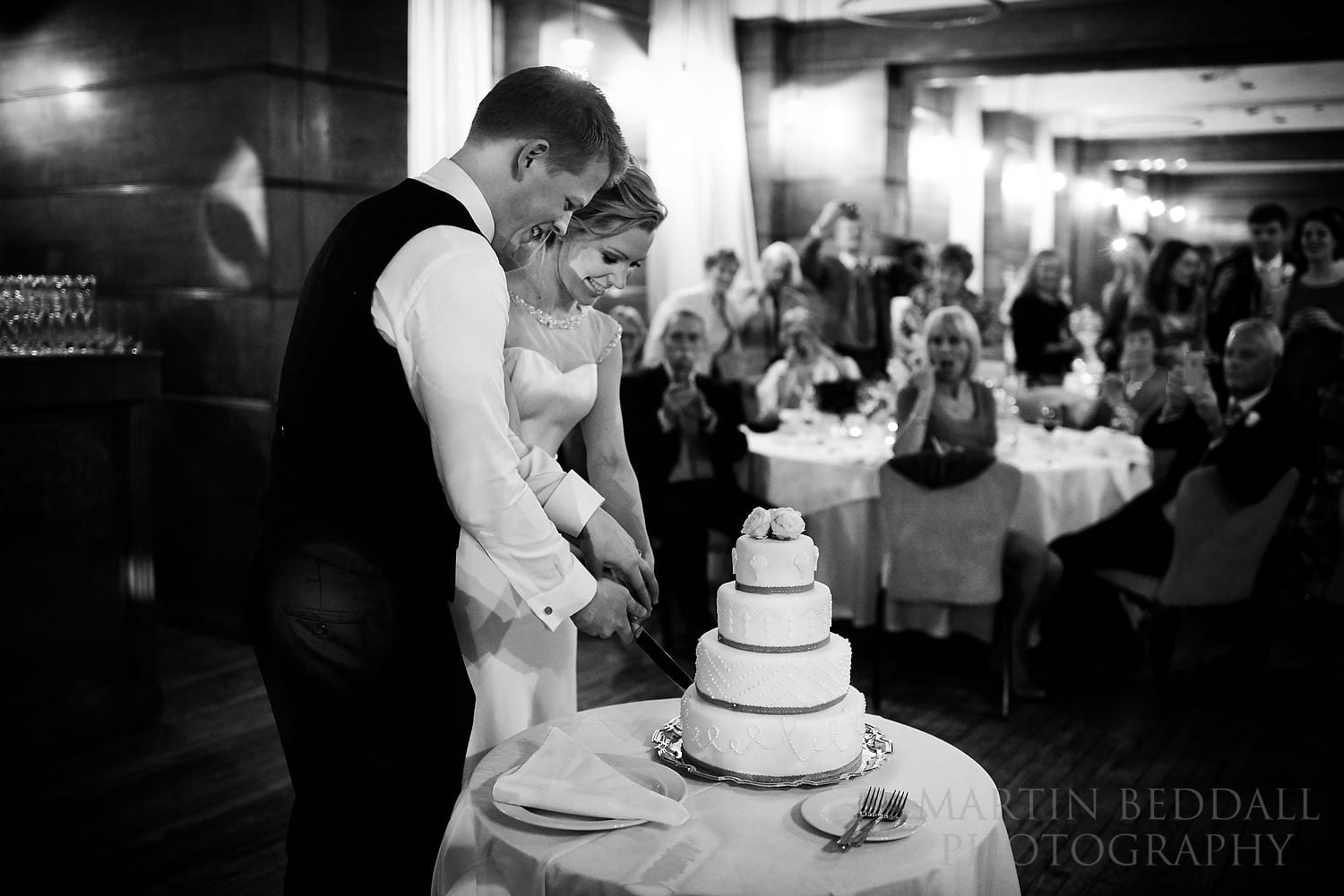 Cutting the wedding cake on the dance floor