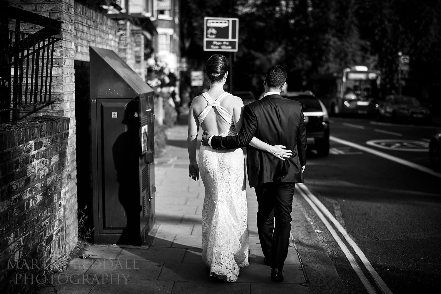 Bride and groom walk back to the pub