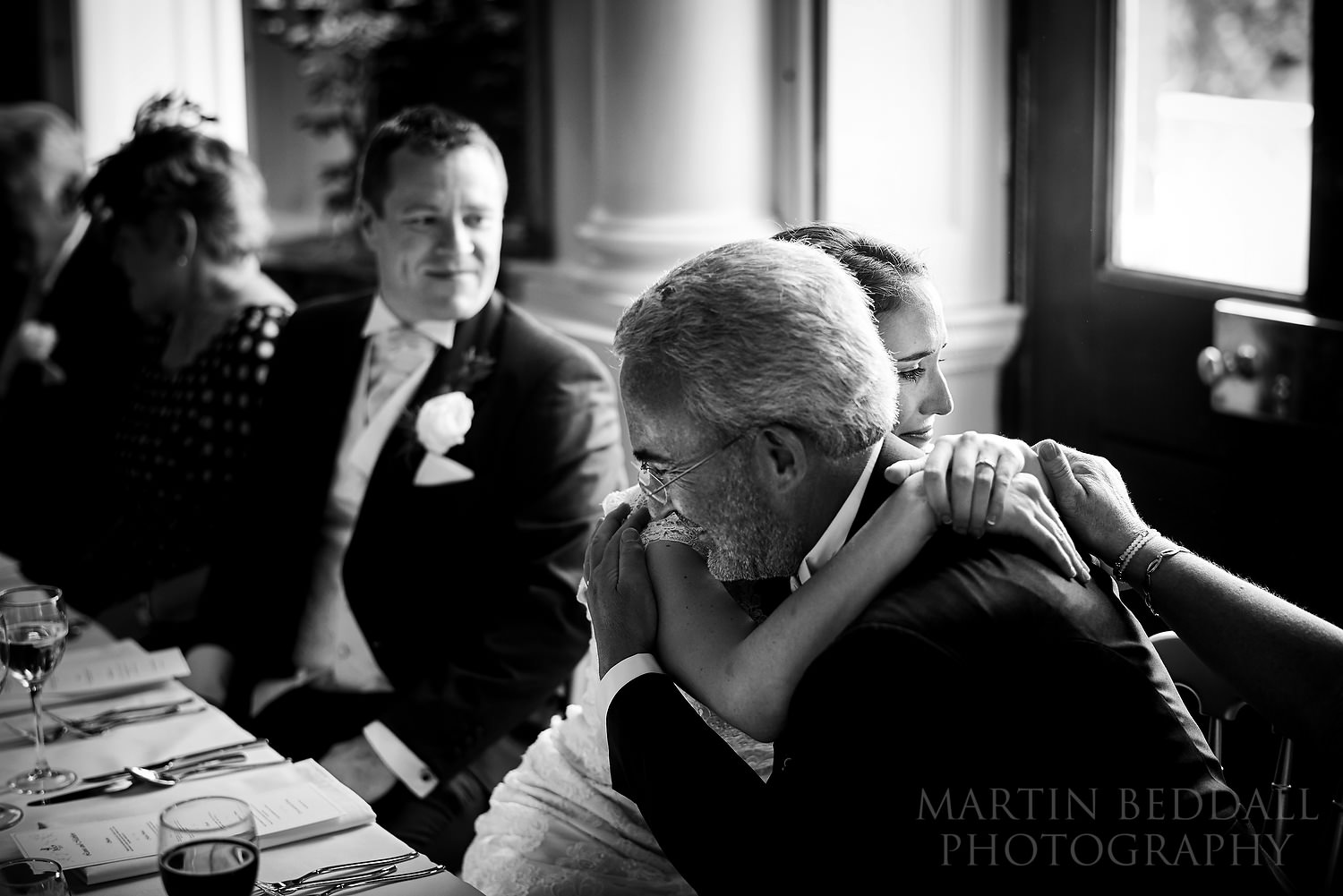 Bride hugs her father after his speech at Kirtlington Park