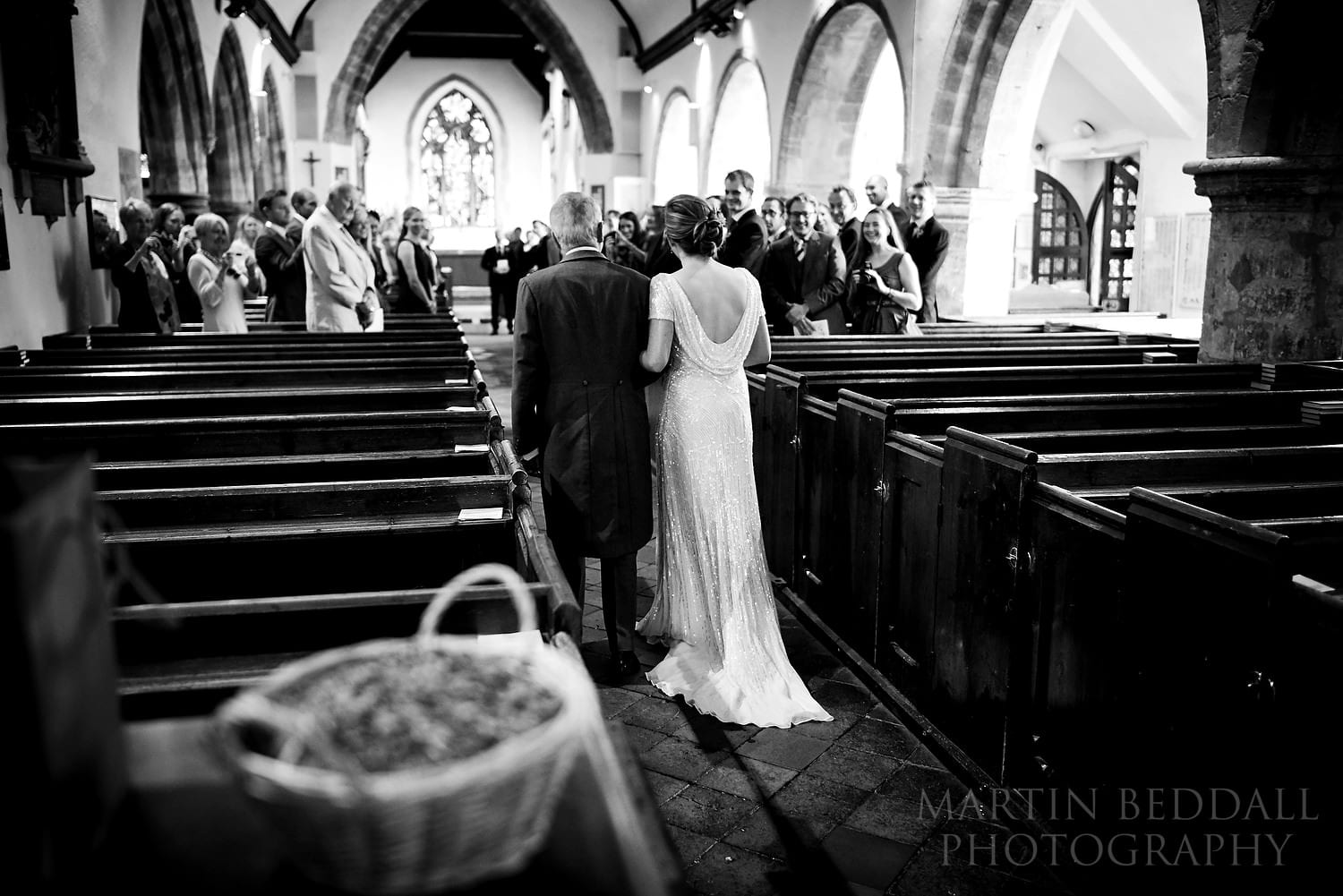 Bride walks down the church aisle with her father