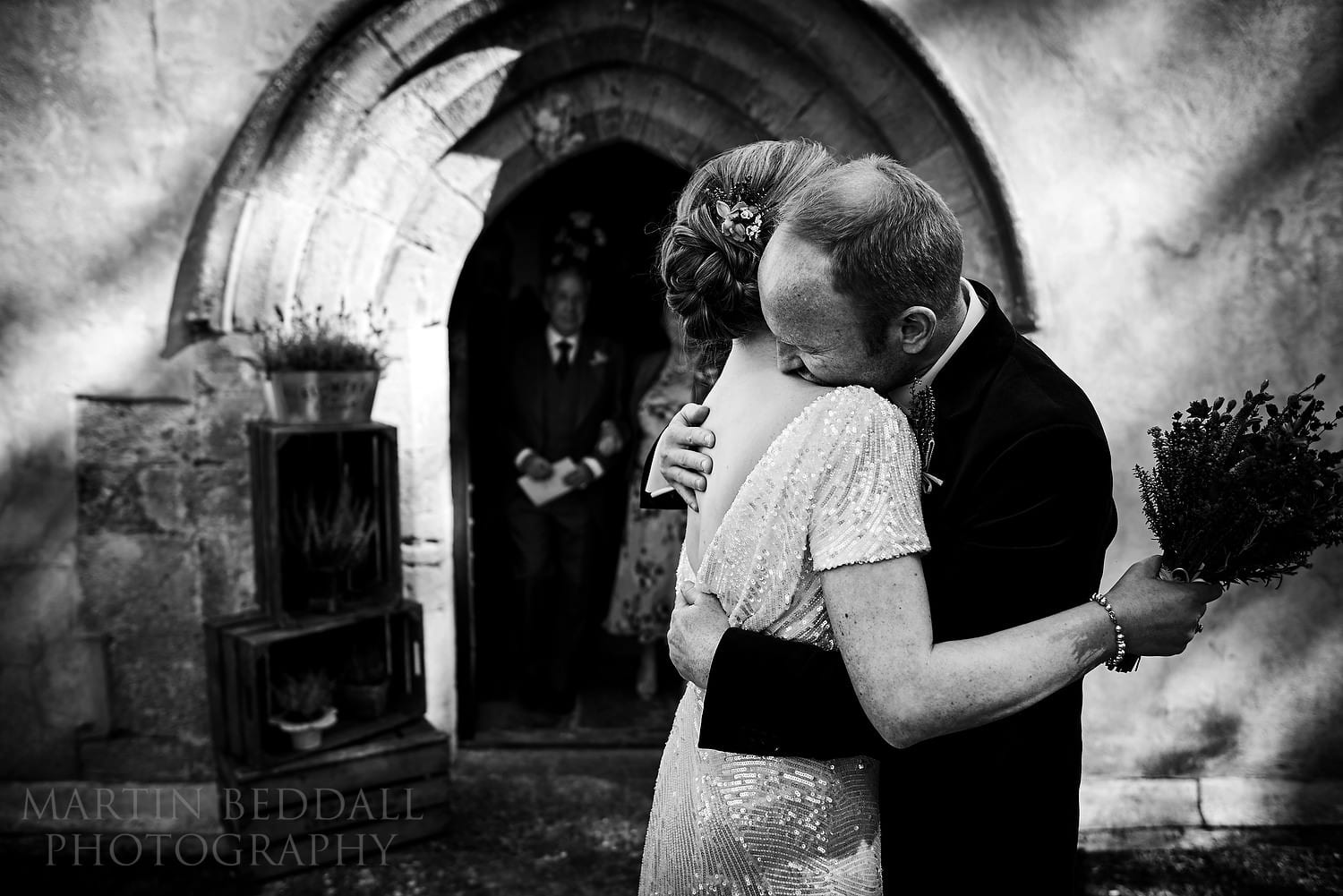 Couple hug outside the chucrh