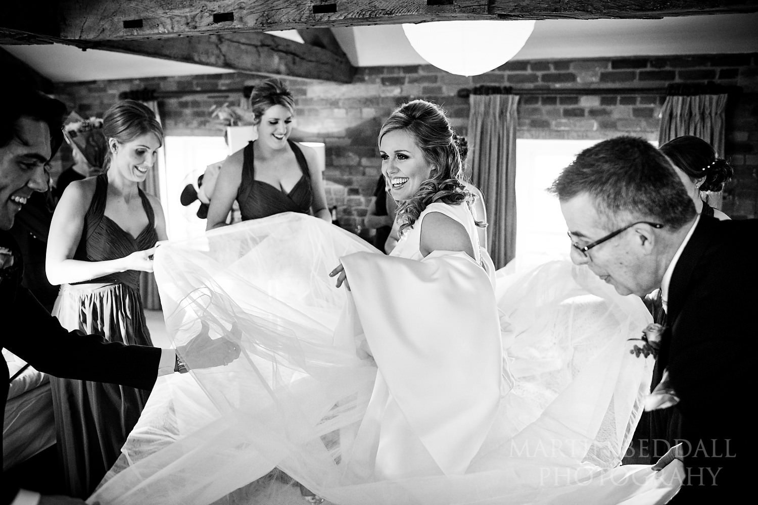 All hands helping with the wedding dress