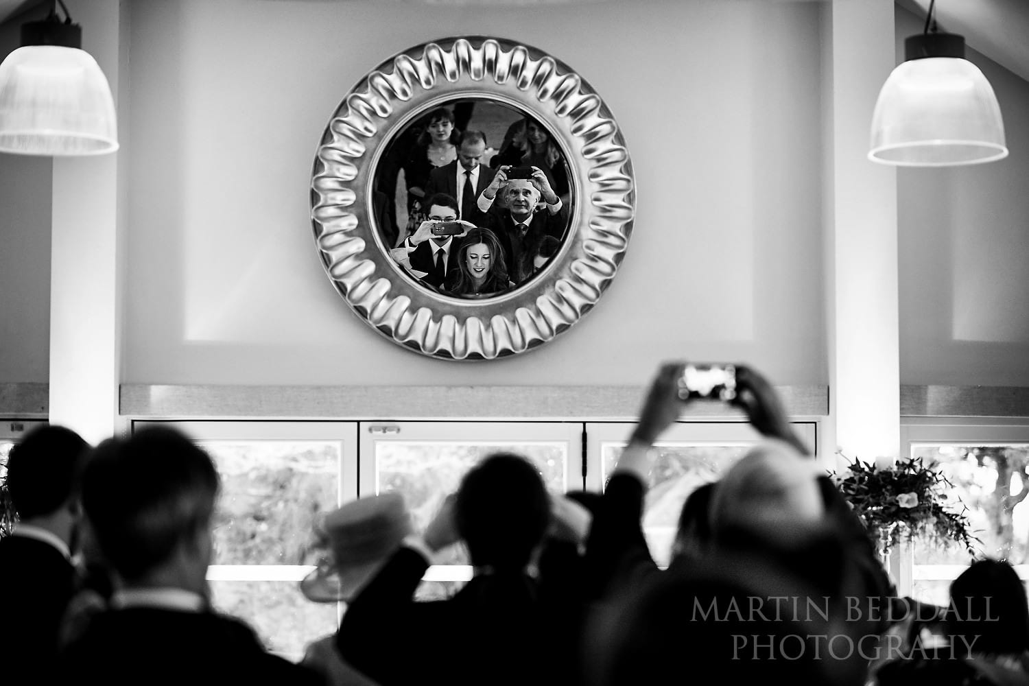 Guests grab a picture of the bride and groom