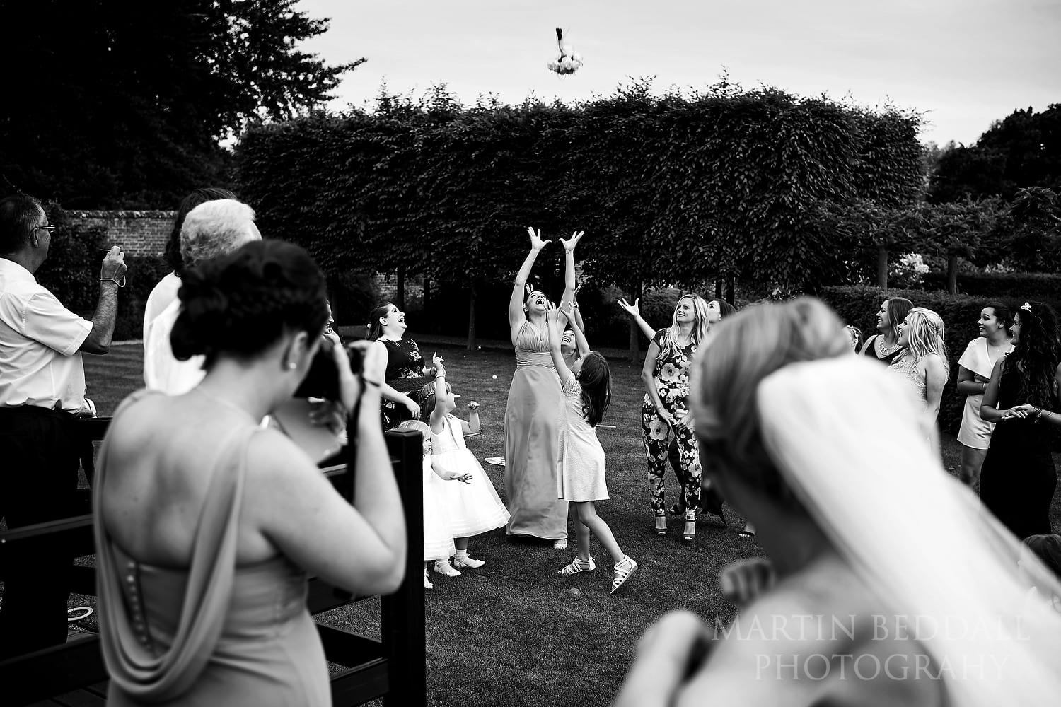 Catching the bride's bouquet at Braxted Park