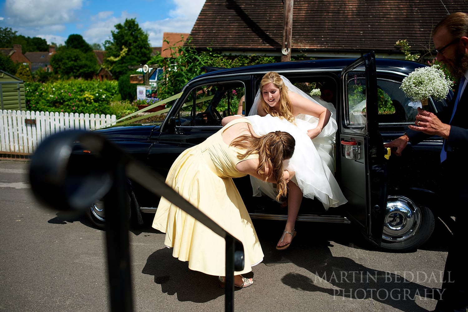 Bride arrives by black taxi cab