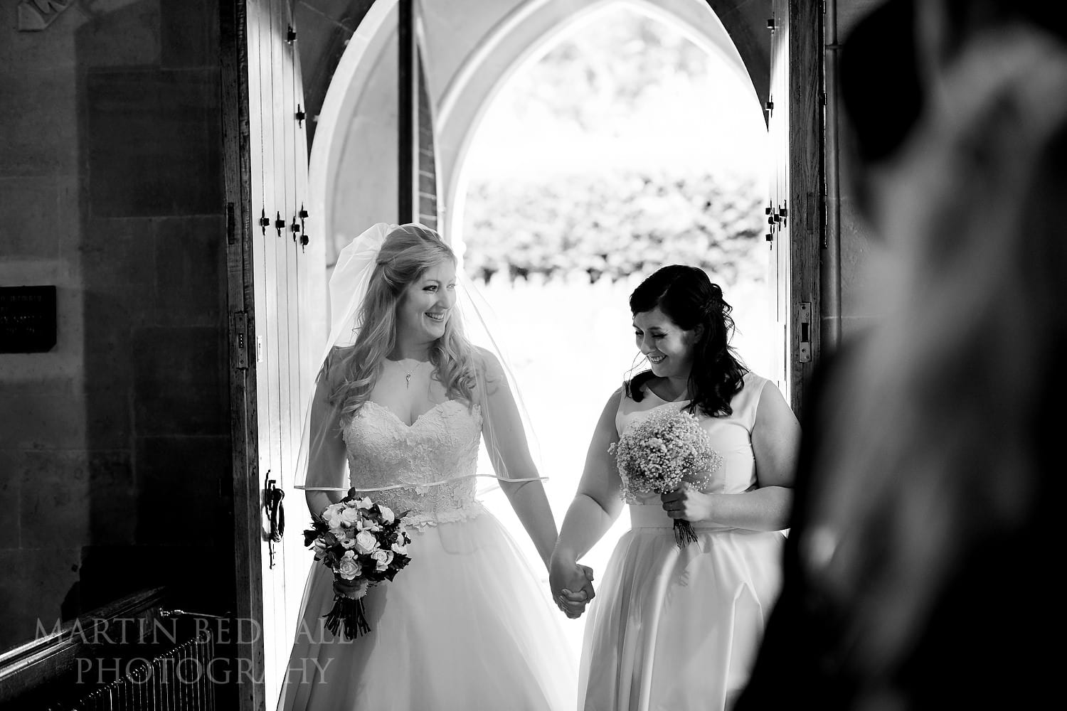 Bride walks into the church with her sister