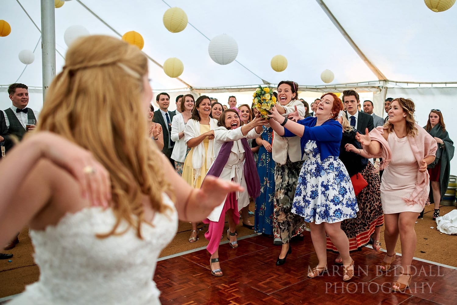 Catching the bride's bouquet at Hatch House wedding