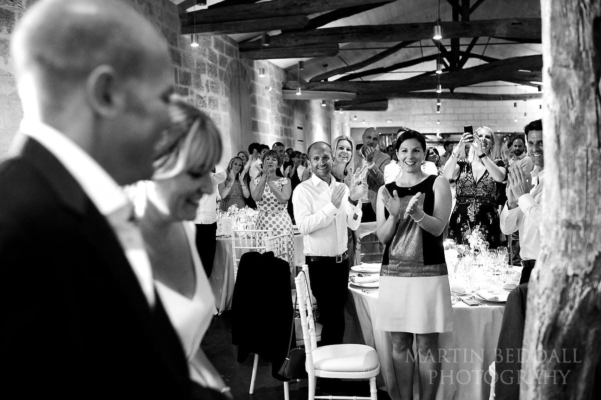 Guests applaud the bride and groom into dinner