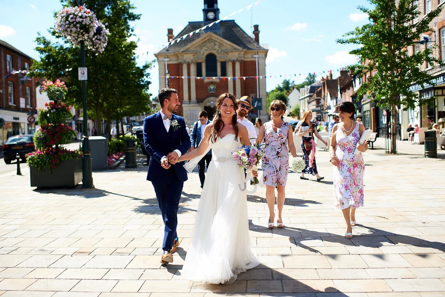 Bride and groom lead the guests to the pub in Henley